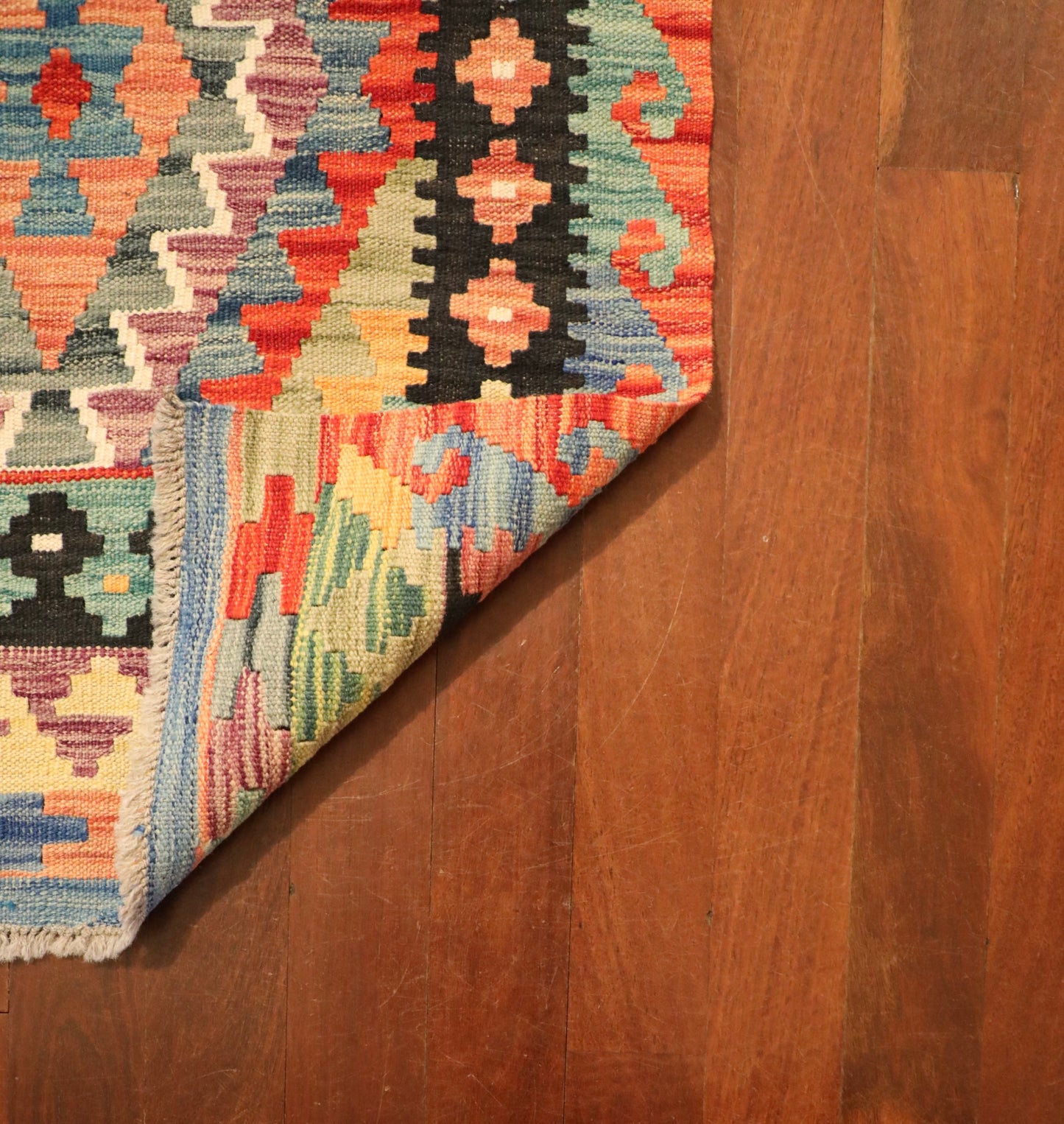 The Afghan Hand Woven Khyber Kilim Runner - 80 X 295. Crafted using traditional vegetable dyed wool, and featuring traditional geometric designs. Colours, ,Oranges, blues, creams, reds, yellows, aqua and more. Measures 80 wide X 295 long. Fold.