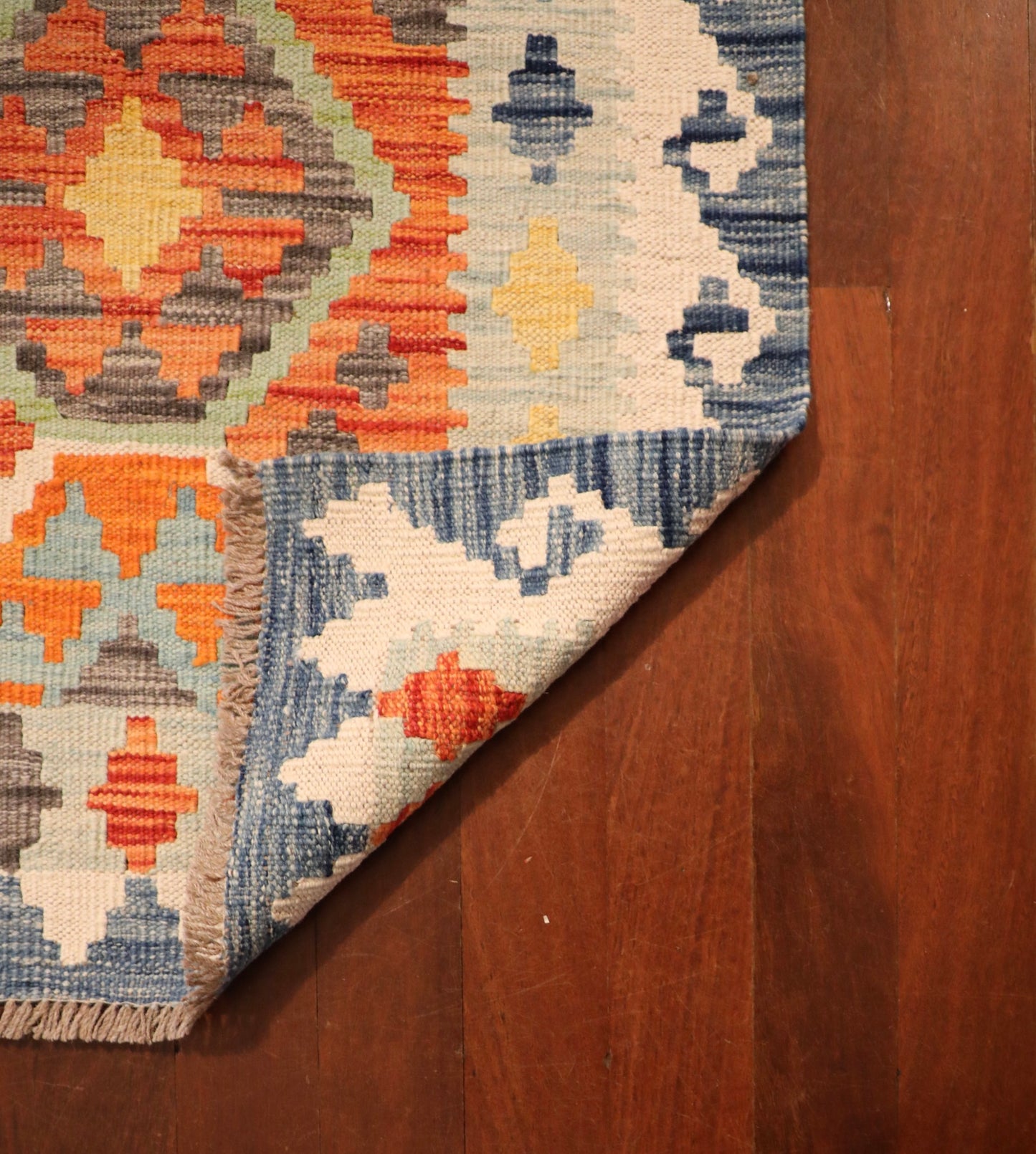 The Afghan Hand Woven Khyber Kilim Runner - 82 X 283. Crafted using traditional vegetable dyed wool, and featuring traditional geometric designs. Colours, blues, yellows, creams, beiges, oranges and more. Measures 82 wide X 283 long. Fold.