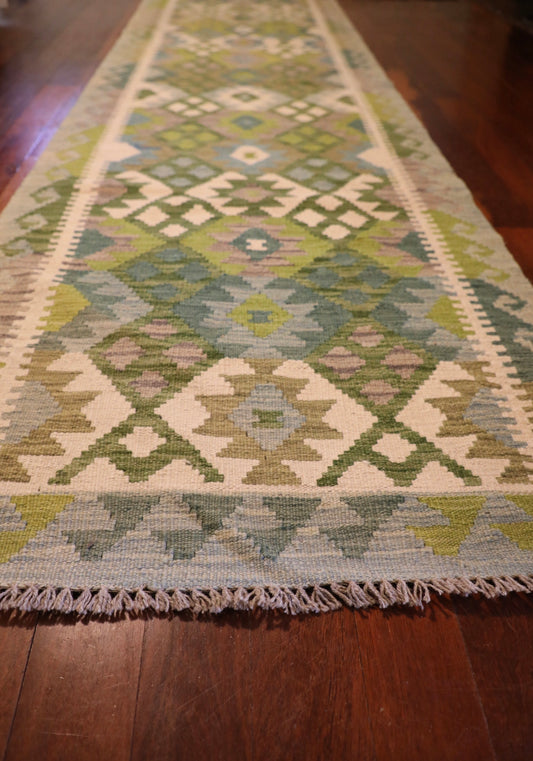 Khyber Kilim Rug Runner 82 X 312. Hand woven wool with vegetable dyes. Colours greens, greys and creams. Measures 82 wide x 312 length. Angle.