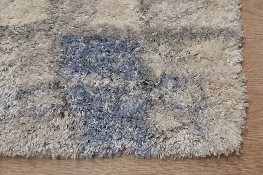 Konya Recta is a Moroccan/Boho inspiration rug. Machine made of Polyester, this shaggy style rugs brings added soften textures. Colours Grey, White, Blue and Light Grey. Sizes 160 X 230, 200 X 290, 240 X 340 and 300 X 400. Corner.