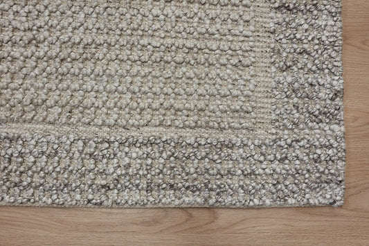 Liberty Limestone is an eco-luxury rug crafted with hand woven recycled PET (plastic bottles) yarn. Boasting a super soft textured loop pile and pile height of 16-18mm. Colour Light Grey and Beige Grey. Sizes 160 X 230, 200 X 290, 240 X 340 and 290 X 390. Corner.