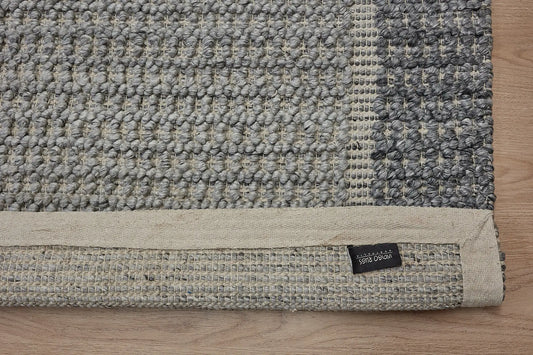 Liberty Slate is an eco-luxury rug crafted with hand woven recycled PET (plastic bottles) yarn. Boasting a super soft textured loop pile and pile height of 16-18mm. Colour Dark Grey and Grey. Sizes 160 X 230, 200 X 290, 240 X 340 and 290 X 390. Fold.