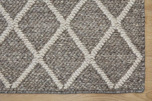 Lounge Taupe is a luxurious wool and bamboo silk rug, featuring a modern Scandinavian Diamond Pattern design and textured hand loomed pile. With pile height of 16-18mm. Colour Brownie/Grey with beige diamond pattern. Sizes 160 X 230, 200 X 290 and 240 X 340. Corner.