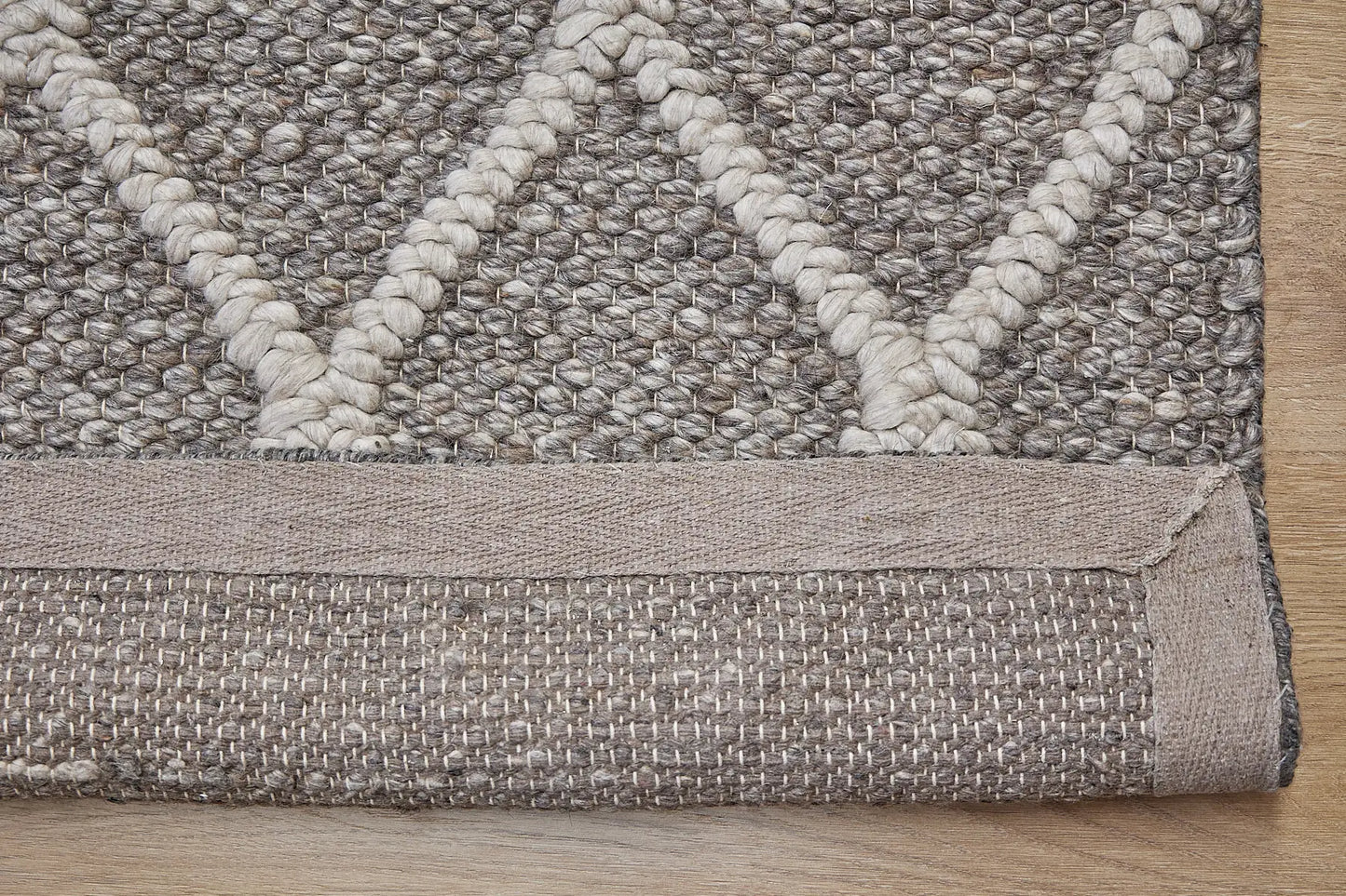 Lounge Taupe is a luxurious wool and bamboo silk rug, featuring a modern Scandinavian Diamond Pattern design and textured hand loomed pile. With pile height of 16-18mm. Colour Brownie/Grey with beige diamond pattern. Sizes 160 X 230, 200 X 290 and 240 X 340. Fold.