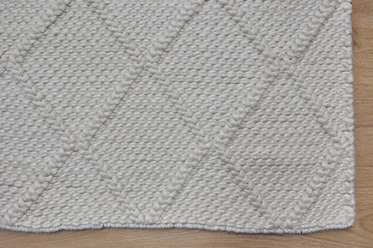 Lounge White is a luxurious wool and bamboo silk rug, featuring a modern Scandinavian Diamond Pattern design and textured hand loomed pile. With pile height of 16-18mm. Colour White with white diamond pattern. Sizes 160 X 230, 200 X 290 and 240 X 340. Corner.