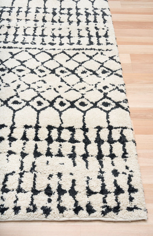 Luana Ivory Charcoal 71 is a machine made polypropylene rug. It features a shaggy pile with a moroccan boho inspired design. Colours Ivory with a charcoal tribal pattern. Sizes 160 X 230, 200 X 290, 240 X 320 and 300 X 390. Corner.