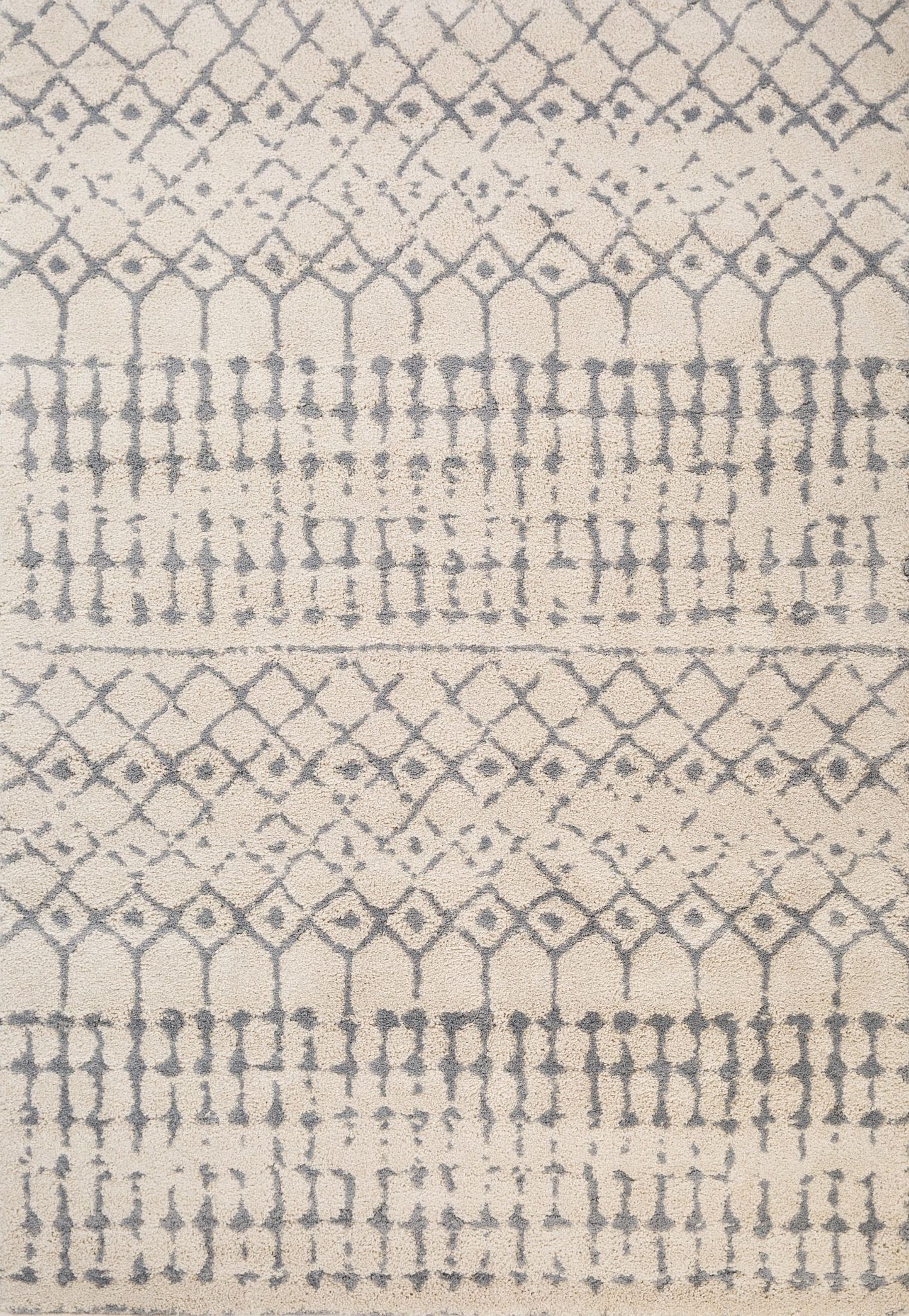 Luana Lattice Ivory Grey is a machine made polypropylene rug. It features a shaggy pile with a moroccan boho inspired design. Colours Ivory with grey moroccan inspired patterns. Sizes 160 X 230, 200 X 290, 240 X 320 and 300 X 390. Top.