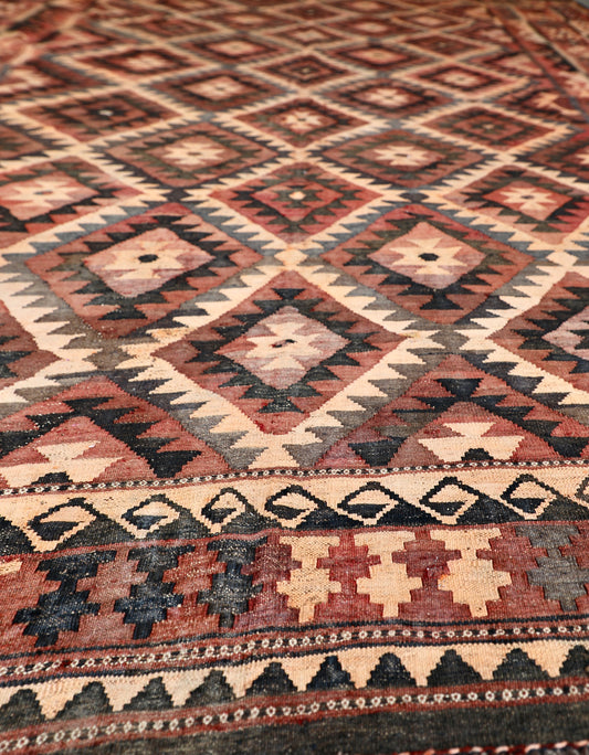 The Afghan Hand Woven Maimana Kilim - 251 X 344. Crafted from wool and featuring traditional Afghan weaving techniques. Colours, red, orange, black. Size 251 wide X 344 long. Angle.