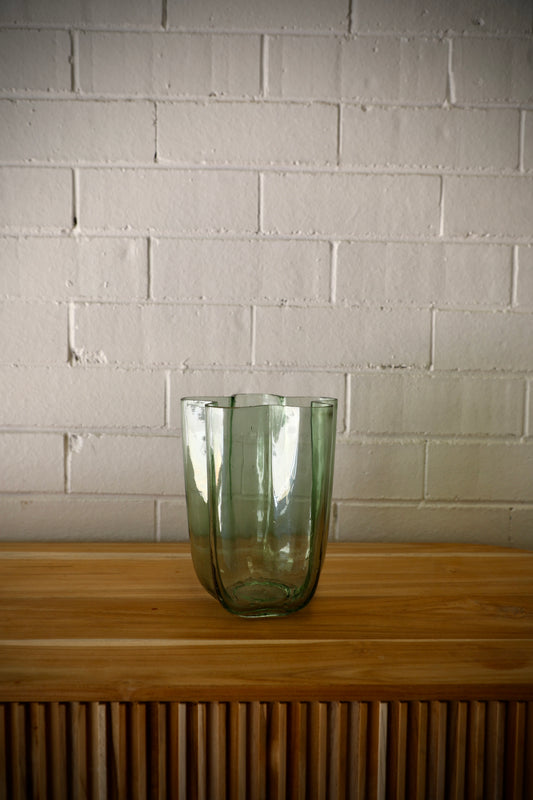 The Miranda Glass Vase is a modern/contemporary piece. Features a curved design. Colour mint green. Measures 15 Diameter X 20 Height. Plain.