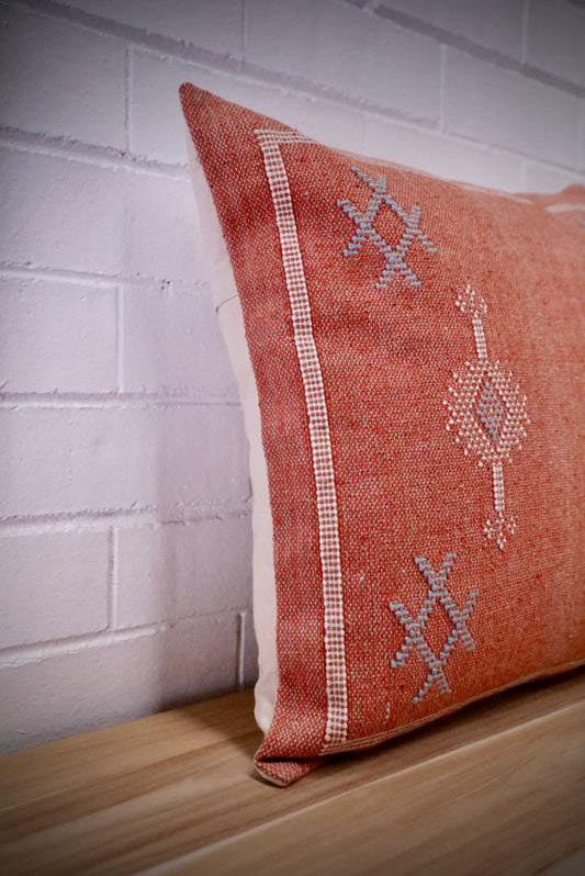 The Moroccan Burnt Orange Cushion is hand crafted in India. Features a cotton weave with hidden zip on the back. This Moroccan inspired design will bring a boho feel to any area. Colours, orange, cream and blues. Measures 50 X 50. Angle.