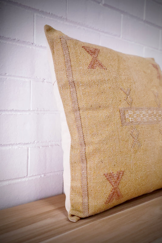 The Moroccan Mustard Yellow Cushion is hand made and features a cotton weave with hidden zip on the back. The Moroccan inspired motif's will bring a tribal feel to any area. Colours, light yellow, cream, brown and blues. Measures 50 X 50. Angle.