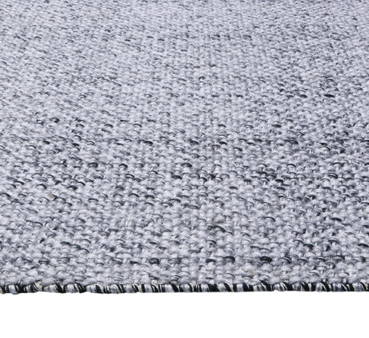 Pacific Black is a handwoven wool and polyester rug with a low-textured cross weave. It boasts a soft pile height of 7-9mm. Colour Black and White. Sizes 160 X 230, 200 X 290, 240 X 340 and 300 X 400. Side.