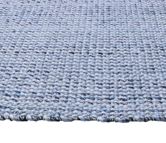Pacific Blue is a handwoven wool and polyester rug with a low-textured cross weave. It boasts a soft pile height of 7-9mm. Colour blue and White. Sizes 160 X 230, 200 X 290, 240 X 340 and 300 X 400. Side.