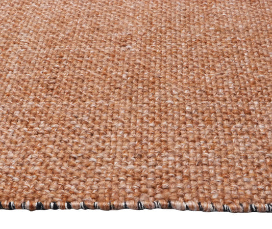 Pacific Terracotta is a handwoven wool and polyester rug with a low-textured cross weave. It boasts a soft pile height of 7-9mm. Colour Terracotta orange. Sizes 160 X 230, 200 X 290, 240 X 340 and 300 X 400. Side.