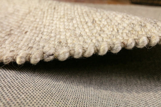 Park Lane Beige is a contemporary hand woven flatweave rug. Made from 80% New Zealand Wool and 20% polyester for a soft and slightly textured feel. Colour Beige. Sizes 155 X 225, 200 X 290, 240 X 320 and 300 X 400. Side.