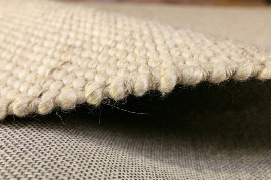 Park Lane Pearl is a contemporary hand woven flatweave rug. Made from 80% New Zealand Wool and 20% polyester for a soft and slightly textured feel. Colour Pearl. Sizes 155 X 225, 200 X 290, 240 X 320 and 300 X 400. Side.