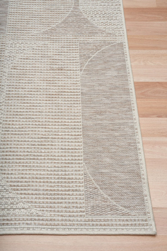 The Patio Linen 65001 indoor/outdoor rug featuring neutral tones and a modern designed pattern, power-loomed from UV-stabilised polypropylene for lasting durability. Colours, Linen, Beiges and hints of light grey. 3 sizes. Corner.