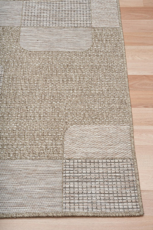 The Patio Straw 50005 indoor/outdoor rug featuring neutral tones and a modern designed pattern, power-loomed from UV-stabilised polypropylene for lasting durability. Colours, Linen, Beiges and hints of light grey. 3 sizes. Corner.