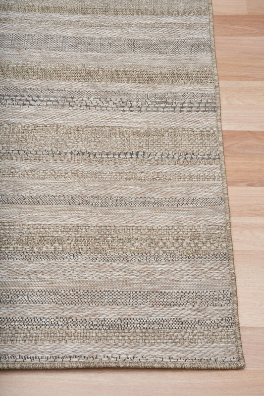 The Patio Straw 900 indoor/outdoor rug featuring neutral tones and a subtle textured pattern, power-loomed from UV-stabilised polypropylene for lasting durability. Colour Browns, Beiges and hints of black. 3 sizes. Corner.