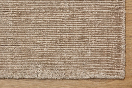Pearl Coral is a luxurious hand-loomed knotted rug made with wool and silky viscose. It boasts a ribbed texture and pile height of 12-14mm. Colour Light Beige. Sizes 160 X 230, 200 X 290 and 240 X 340. Corner.