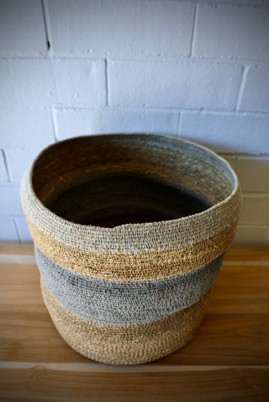 The Port Seagrass Basket - Medium, is crafted from natural seagrass. Its weave creates a rustic texture, perfect for storing most things. Colours, Natural and Steel. Measures 28 Diameter X 28 Height. Top.