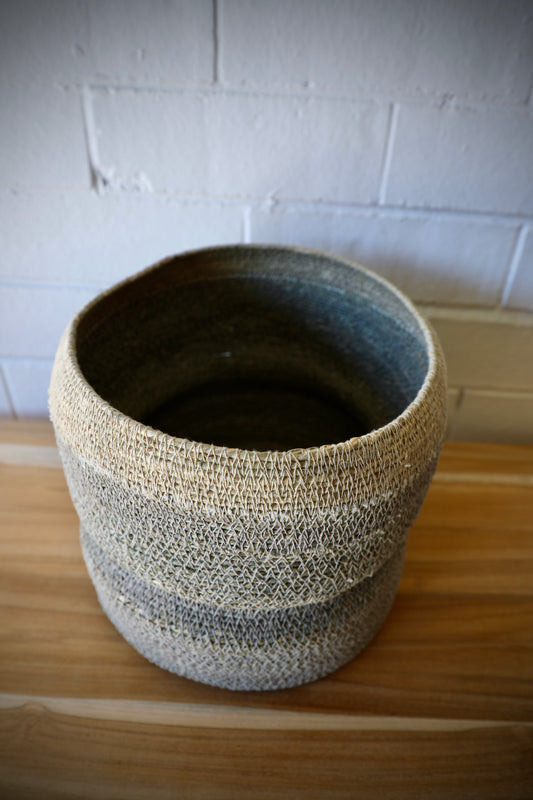 The Port Seagrass Basket - Small, is crafted from natural seagrass. Its weave creates a rustic texture, perfect for storing most things. Colour Steel. Measures 22 Diameter X 22 Height. Top.