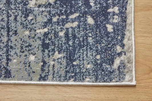 Raj Indigo is a machine made rug. Its design boasts a modern/contemporary feel. Crafted from Viscose and Polyester, with a low-profile 7-9mm pile height. Colours Light Grey with blue and white accents. Sizes 160 X 230, 200 X 290, 240 X 340 and 300 X 400. Corner.