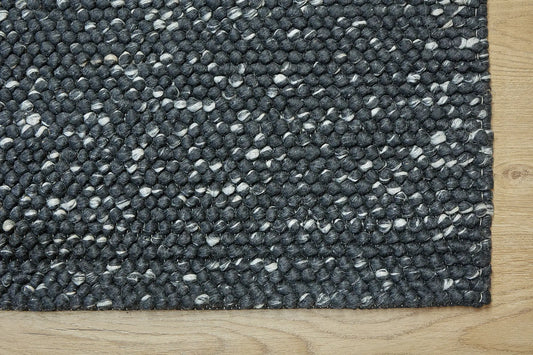 Rocks Black is a luxurious hand-woven wool carpet. Boasting a plush loop pile with 8-18mm pile height. Colour Black with white accents. Sizes 160 X 230, 200 X 290, 240 X 340 and 290 X 390. Corner.