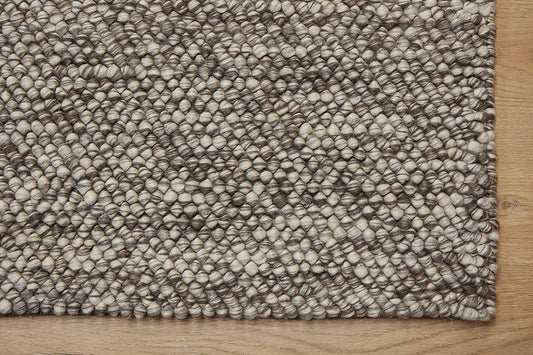 Rocks Brown is a luxurious hand-woven wool carpet. Boasting a plush loop pile with 8-18mm pile height. Colour Brown with beige accents. Sizes 160 X 230, 200 X 290, 240 X 340 and 290 X 390. Corner.