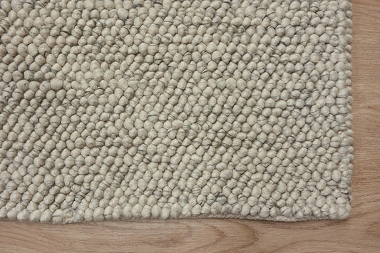 Rocks White is a luxurious hand-woven wool carpet. Boasting a plush loop pile with 8-18mm pile height. Colour White with grey accents. Sizes 160 X 230, 200 X 290, 240 X 340 and 290 X 390. Corner.