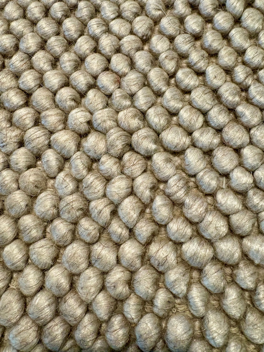 Rusta Beige hand-woven wool rug featuring a looped pile textured design in soft neutral beige tones, ideal for modern and contemporary interiors. Sizes 155 X 225, 200 X 290, 240 X 320 and 300 X 400. Fibres Close.