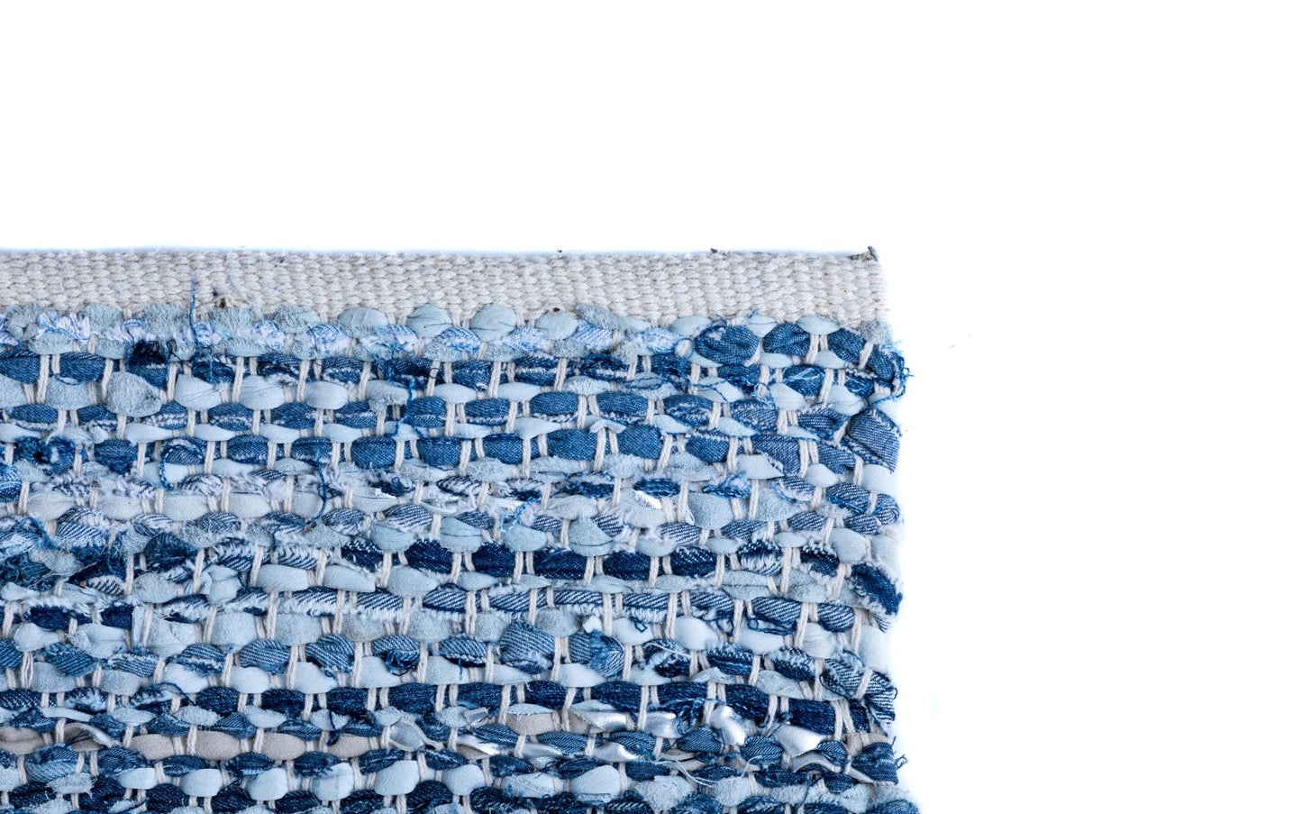 Rustic Charm Blue is a hand woven natural jute and leather carpet. Colour Light Blue and Blue. Sizes 155 X 225, 200 X 290, 240 X 320 and 300 X 400. Corner.