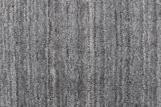 Shadow Fossil is a hand-tufted rug from a blend of wool and silky viscose with a smooth pile and a 12-14mm pile height. Colour Silver with light grey and black accents. Sizes 160 X 230, 200 X 290 and 240 X 340. Close.