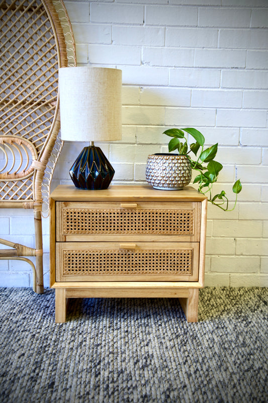 The Shasta 2 Drawer Natural Bedside offers a modern coastal aesthetic. Crafted from white cedar and rattan and featuring two drawers, on wood runners. Colour natural. Measures 600 wide X 350 depth X 500 height. Front Styled.