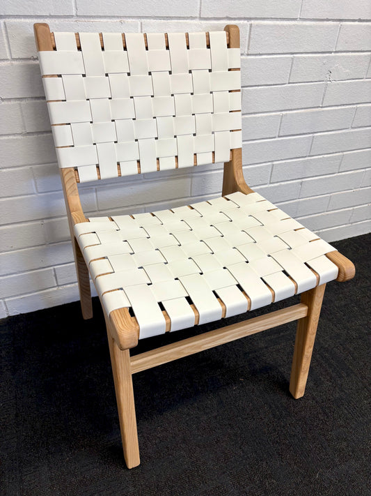 The Shawnee - White Dining Chair, features an ash frame and white saddle leather. It has a strapped seat and back. Colours, natural frame with white leather. Measures 510 wide X 420 depth X 460 Seat height. Back height 840. Angle.
