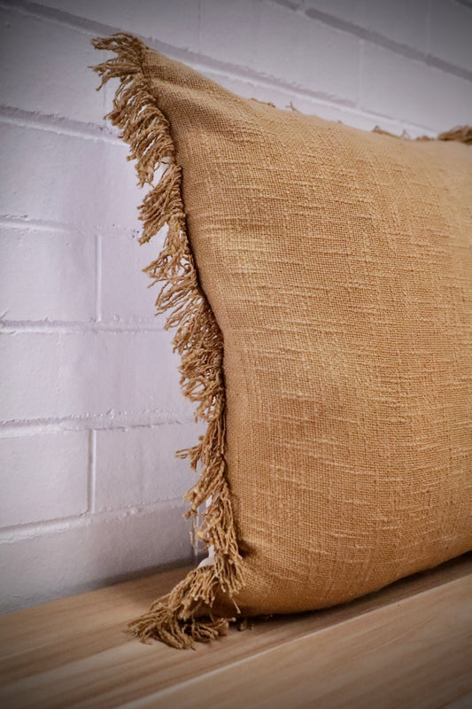The Sun Baked, yellow, throw cushion is made by skilled artisan weavers in India. Crafted from cotton slub, it features a luxurious textured feel. Boasts tasseled edges. Colour burnt yellow. Sizes, 50 X 50 and 60 X 60. Angle.