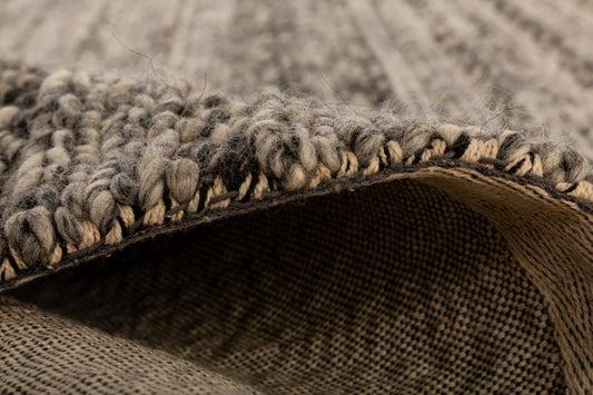 Svend Silver Grey is a contemporary hand woven braided pile wool rug. Colour Dark Grey, Grey and Light Grey. Sizes 155 X 225, 200 X 290, 240 X 320 and 300 X 400. Side.