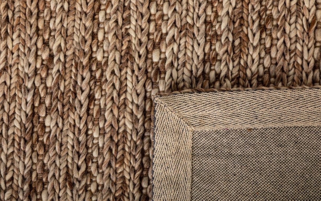 Svend Taupe is a contemporary hand woven braided pile wool rug. Colours Taupe Brown with Beige accents. Sizes 155 X 225, 200 X 290, 240 X 320 and 300 X 400. Fold.