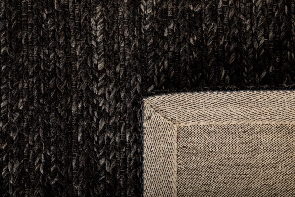 Svend Charcoal is a contemporary hand woven braided pile wool rug. Colour Charcoal/black. Sizes 155 X 225, 200 X 290, 240 X 320 and 300 X 400. Fold.