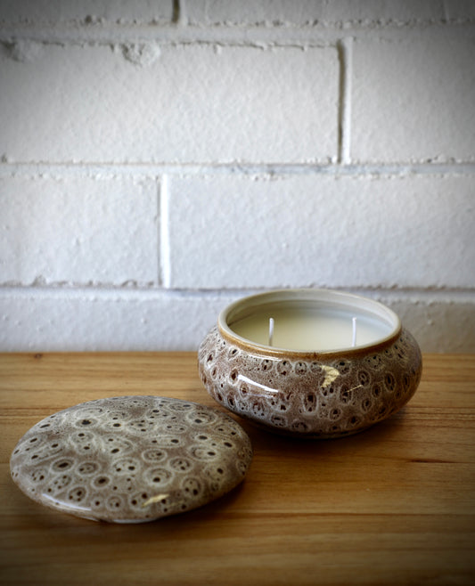 The Terra Ceramic Candle Jar, features a main dish for the candle and a lid to cover when not in use. Colours rustic grey with black specs. Measures 12.5 Diameter X 7 Height. Open.