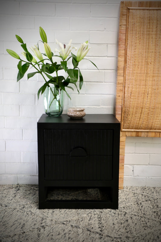 The Teton 2 drawer black bedside is crafted from sustainable fruitwood. Its contemporary design features two generous drawers, on wood runners. Colour black. Measures 550 wide X 350 depth X 550 height. Front Styled.