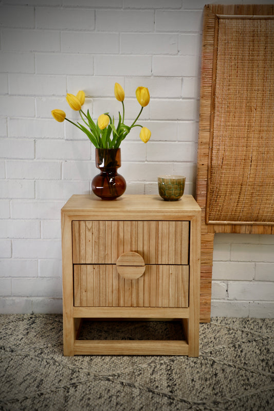 The Teton 2 drawer natural bedside is crafted from sustainable fruitwood. Its contemporary design features two generous drawers, on wood runners. Colour natural. Measures 550 wide X 350 depth X 550 height. Front Styled.