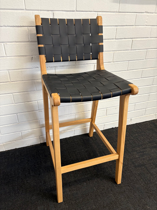 The Thames w/back black leather barstool features black strapped saddle leather on an ash frame. measures 410 wide X 320 depth X 660 seat height. Angle.