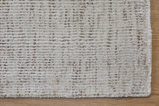 Toro Beige is a hand-loomed, hand-knotted rug with a contemporary multi-fleck design. Wool and silky viscose are blended to create a soft feel with its 10-12mm pile height. Colour light beige with brown accents. Sizes 160 X 230, 200 X 290, 240 X 340 and 300 X 400. Corner.