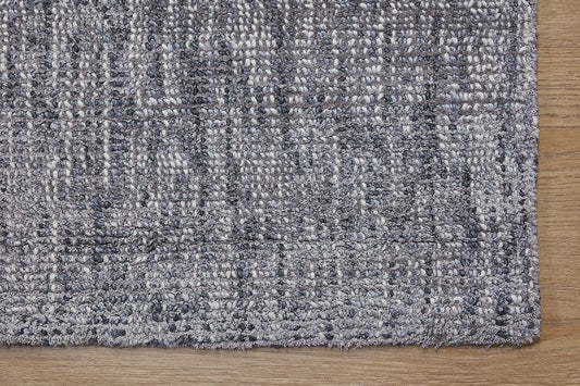 Toro Slate is a hand-loomed, hand-knotted rug with a contemporary multi-fleck design. Wool and silky viscose are blended to create a soft feel with its 10-12mm pile height. Colour Dark Grey with silver accents. Sizes 160 X 230, 200 X 290, 240 X 340 and 300 X 400. Corner.