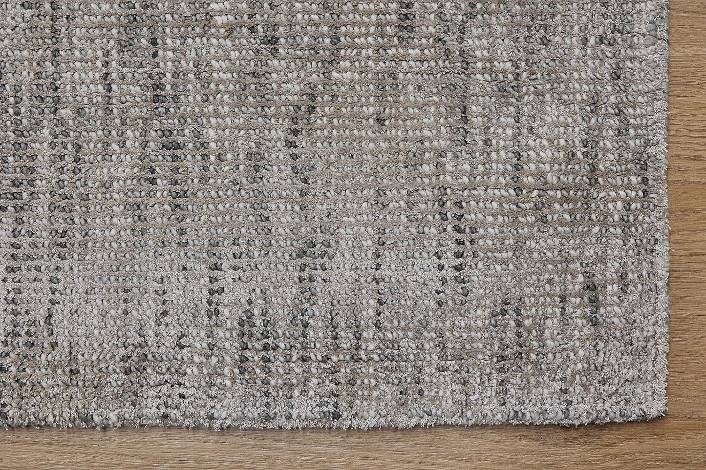 Toro Taupe is a hand-loomed, hand-knotted rug with a contemporary multi-fleck design. Wool and silky viscose are blended to create a soft feel with its 10-12mm pile height. Colour Beige with cream and black accents. Sizes 160 X 230, 200 X 290, 240 X 340 and 300 X 400. Corner.