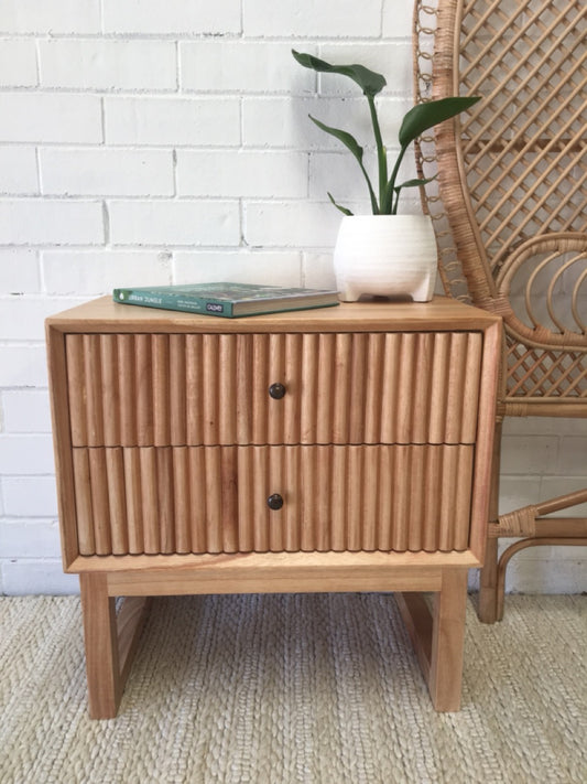 The Whistler 2 Drawer Bedside is crafted from sustainable white cedar and features two drawers, on wood runners, with a stylish textured drawer cover. Colour natural. Measures 600 wide X 350 depth X 600 height. Front Styled.