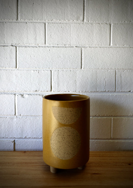 The Zod Ceramic Pot - Large, is a modern simplistic designed planter pot. Its smooth texture and round feet add a modern feel. Colour Orange. Size 14 diameter x 20.5 height. Plain.