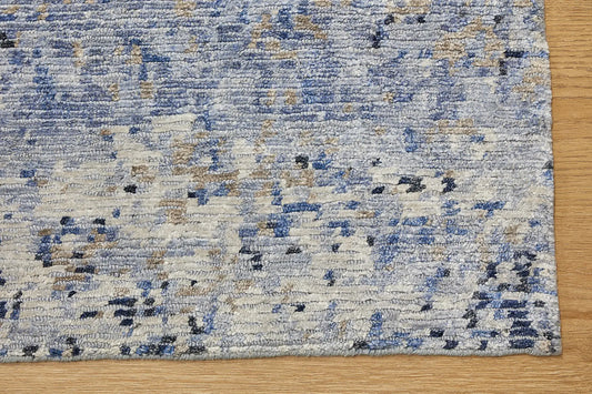 Zurich Blue is a luxurious contemporary/modern designed rug. Hand Knotted from a blend of wool and bamboo Silk. Colours Blues, whites, and greys. Sizes 200 X 290, 250 X 300 and 270 X 360. Corner.