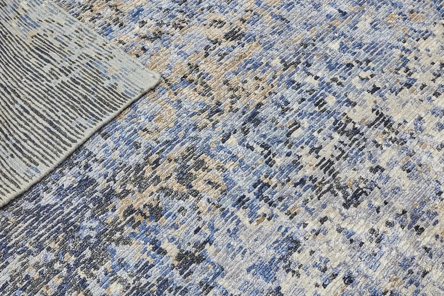 Zurich Blue is a luxurious contemporary/modern designed rug. Hand Knotted from a blend of wool and bamboo Silk. Colours Blues, whites, and greys. Sizes 200 X 290, 250 X 300 and 270 X 360. Fold.
